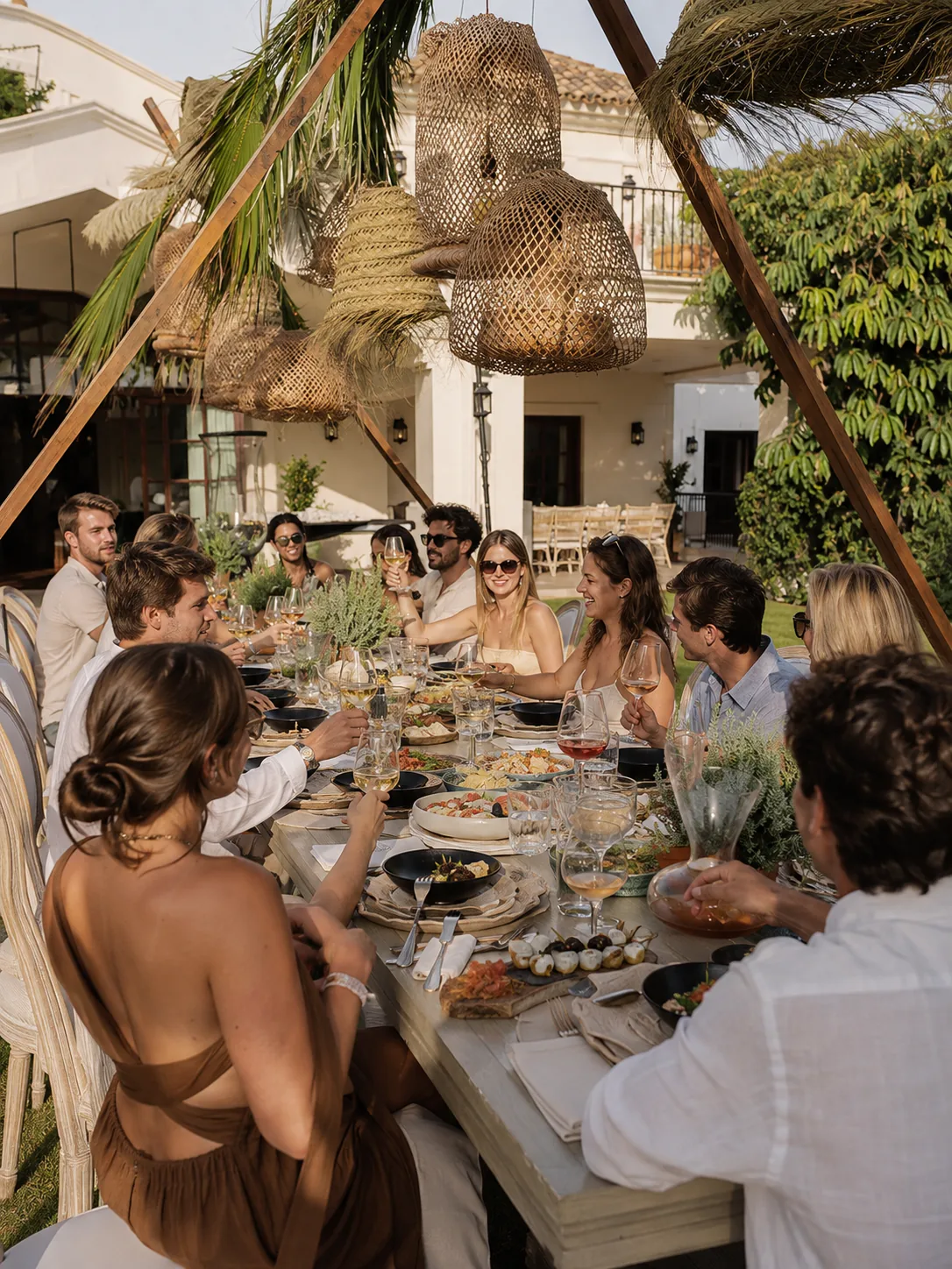 Friends enjoying a relaxed private celebration around a Mediterranean table